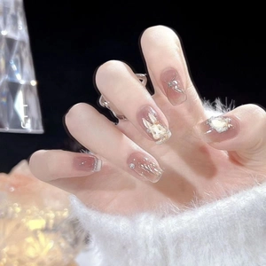 Handmade 3D rabbit press-on nails with pearls and pink base on model's hand