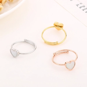 Three minimalist heart rings in gold, silver, and rose gold on a clean white background