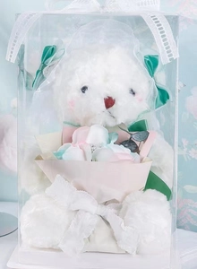 Transparent gift box featuring a white plush bear and multi-colored soap flower bouquet
