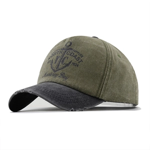 Detail of olive cotton baseball cap with anchor print and distressed brim texture
