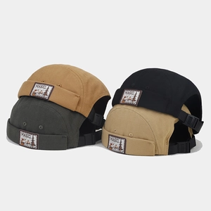 Detail of canvas docker hats showing adjustable rear straps and woven labels in four colors