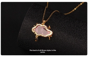 Close-up of the smooth back structure of the golden cloud pendant with lightning detail