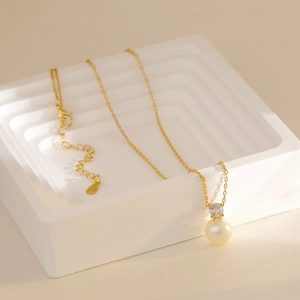 Classic gold snake chain necklace with round white pearl and sparkling zircon pendant