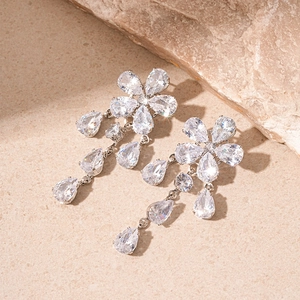 Detailed close-up of crystal flower drop earrings with sparkling teardrop stones