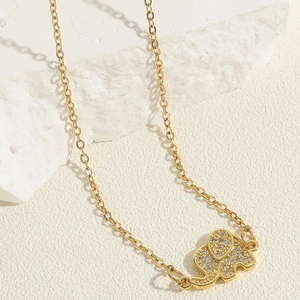 Close-up of golden elephant pendant with shimmering zircon pavé on a fine O-chain