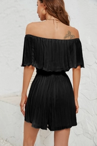 Detail of black off-the-shoulder pleated romper showing elegant back view and texture