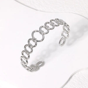 Minimalist silver stainless steel open bangle featuring a unique linked ring design