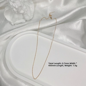 Close-up of a 0.7mm gold-plated S925 silver beaded O-chain on a white silk background