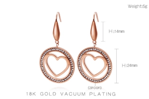 Detail view of 18K rose gold heart earrings with zircon inlay and weight marking