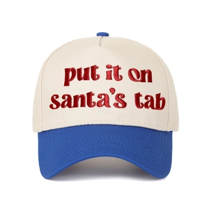 Detail showing red embroidered 'put it on santa's tab' text on canvas baseball cap