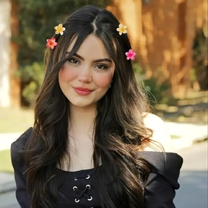 Close-up of a model wearing colorful candy-colored flower hair claws in a sweet outdoor setting