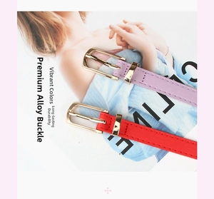 Detail of slim PU leather belts in purple and red with elegant gold alloy buckles