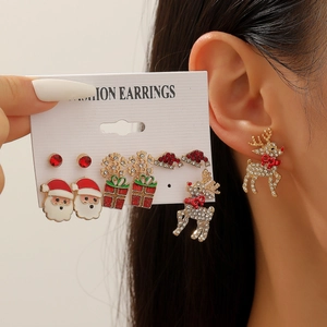 Detailed close-up of a festive Christmas earring set with Santa and reindeer motifs