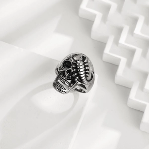 Punk 316L stainless steel ring with detailed skull and scorpion design on stone plinth