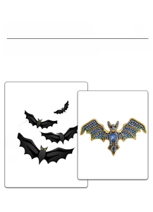 Macro detail of gothic devil bat brooch with blue rhinestones and gold metal base