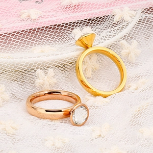 Elegant gold and rose gold stainless steel rings with large clear crystals on lace fabric