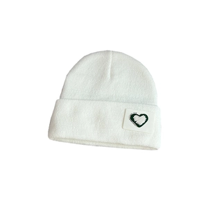 White knitted beanie with green heart embroidery patch and cuff for kids winter warmth