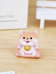 Mini Shiba Inu resin figurine holding a golden ingot on a wooden table with soft lighting