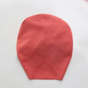 Detailed view of pink cashmere-like baby turban hat with pearls and floral accent