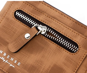 Detailed macro view of the NBENSE brown textured leather wallet with premium metal zipper