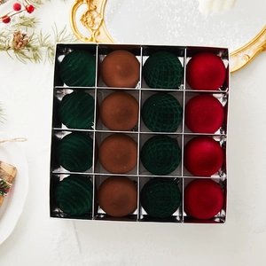 Detail of 16-piece flocked Christmas ornaments in red, green, and brown velvet finish