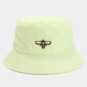 Close-up of high-quality bee embroidery on a breathable light green cotton bucket hat