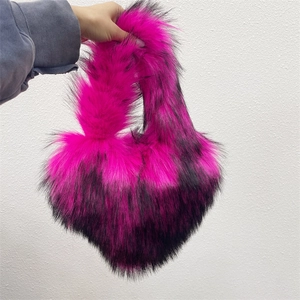 Detailed view of heart-shaped faux fur bag with magenta to black gradient plush