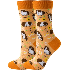 Close-up of orange crew socks featuring cute guinea pig and daisy patterns in high detail