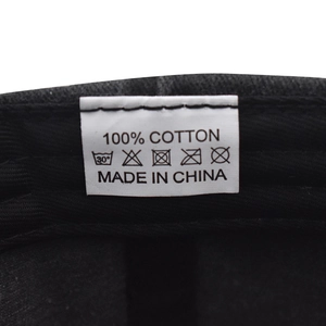 Detail view of cotton baseball cap washing label showing 100 percent cotton material