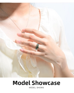 Three-stone ring featuring round-cut green moissanite set in polished silver on model