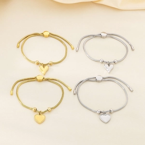 Adjustable 18K gold and silver snake bone chain bracelets with heart-shaped pendants