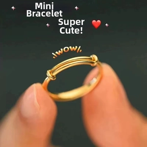 Close-up of golden enamel daisy open ring with adjustable band on person's hand