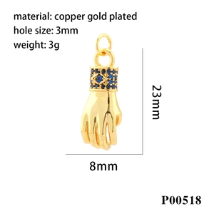 Detailed macro view of 18k gold plated copper hand pendant with blue zircon stones