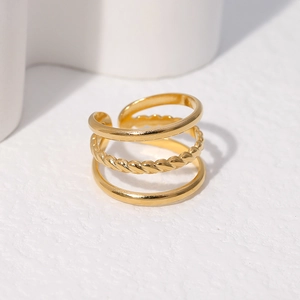 Detailed view of triple-layered golden ring with twisted rope texture and open band