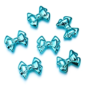 Detailed view of six metallic blue bow charms for DIY jewelry and phone chain accessories