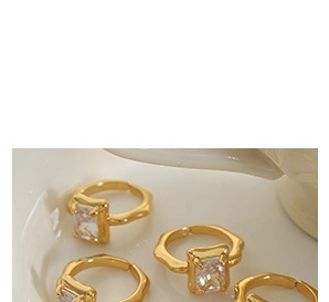 Detail view of 18k gold plated open rings with wavy texture and rectangular zircon stones