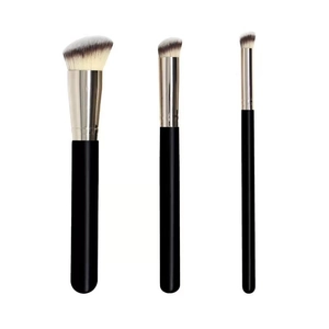 Set of 3 professional makeup brushes with black handles and silver ferrules on white background