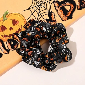 Macro shot of Halloween scrunchie with pumpkin and skull patterns on black fabric