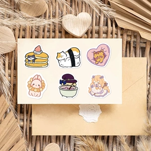 Artistic detail of cute cartoon stickers with cat and dessert patterns on beige card