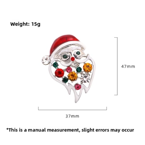 Detailed view of Santa brooch with colorful rhinestones and red enamel coating