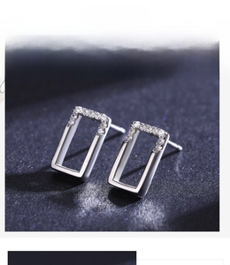 Macro shot of 925 silver rectangular stud earrings with micro-pave cubic zirconia