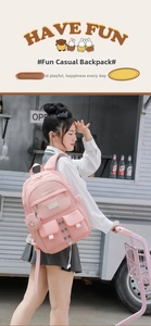 Detail of pink multi-pocket nylon backpack with side coin purse on outdoor stroller
