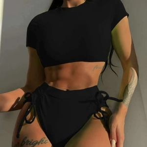Two-piece black bikini featuring short sleeve crop top and side lace-up high waist shorts