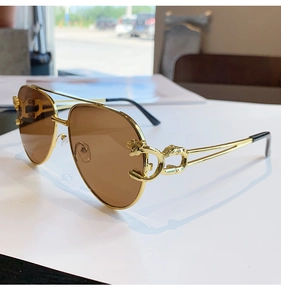 Detailed view of the gold leopard head emblem on double bridge pilot sunglasses