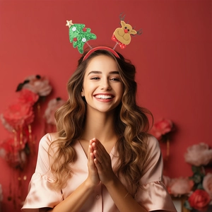 Detail of Christmas headband with green sequin tree and reindeer on red plush band
