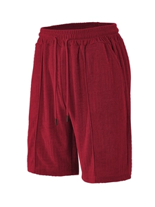 Detailed view of dark red sports shorts featuring textured jacquard fabric and drawstring