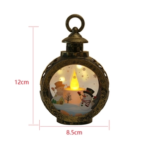 Detailed view of bronze Christmas lantern with LED candle and snowman scene, 12x8.5cm
