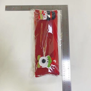 Detail of 4-piece red burlap Christmas handle covers with 3D snowman and elf decor