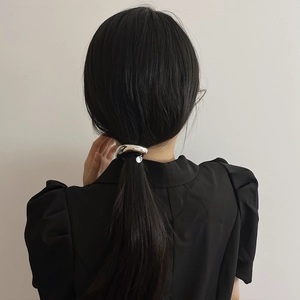 Silver arched metal hair tie on a low ponytail ponytail hair cuff for women's hairstyle