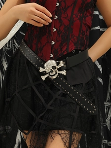 Detail of punk style black belt with rhinestone skull buckle and metal studs on a model